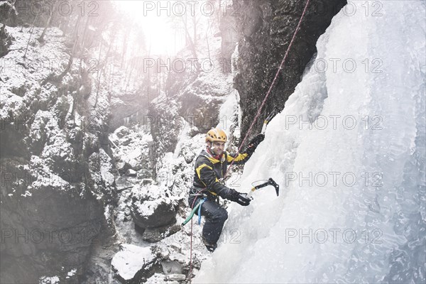 Ice climber climbing a frozen waterfall