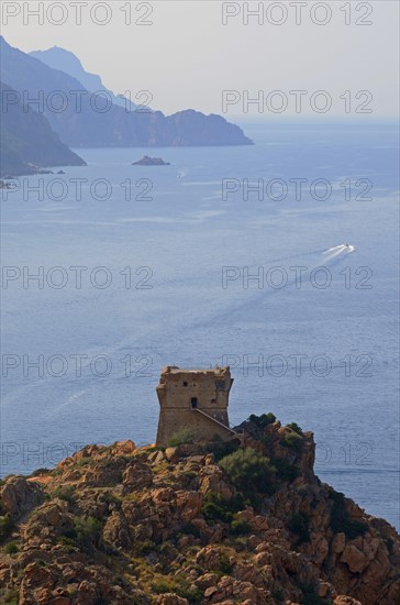 The Genoese Tower of Porto on top of a rocky hill and the Gulf of Porto