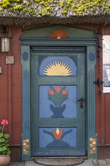 Carved and painted door of a wooden house