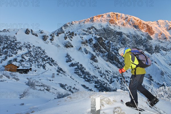 Man snowshoeing towards Carl-von-Stahl-House on Torrener Joch pass