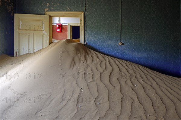 Building taken over by sand from the desert