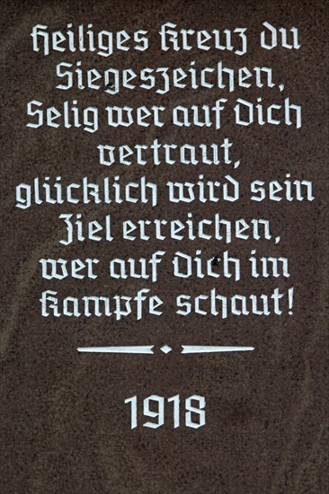 Religious inscription on the base of a wayside cross