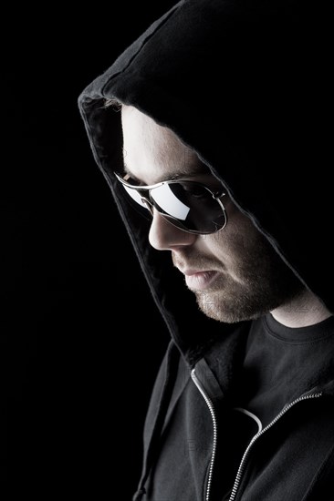 Man wearing sunglasses and a hood