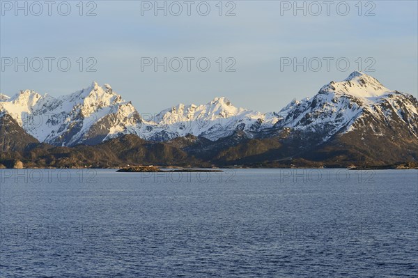 Snow-covered mountains on Hadselfjord in the evening light