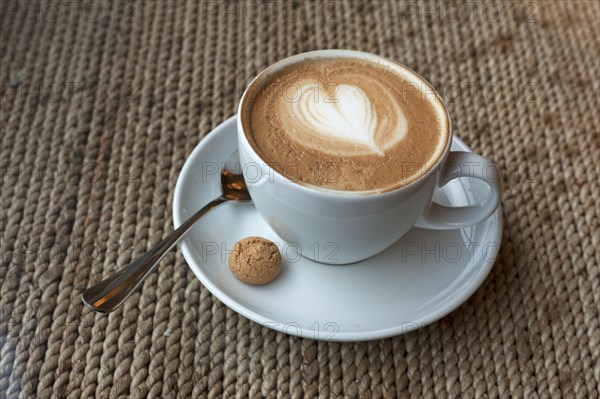 Cup of cappuccino with milk foam heart