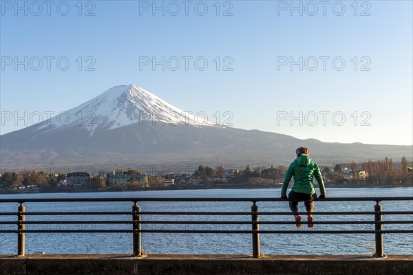 Young woman sitting on a railing