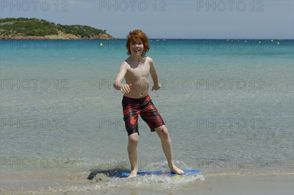 Boy surfing with his boogie board