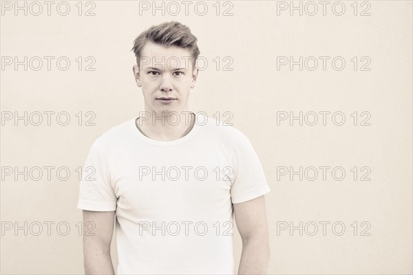 Portrait of young man in front of wall