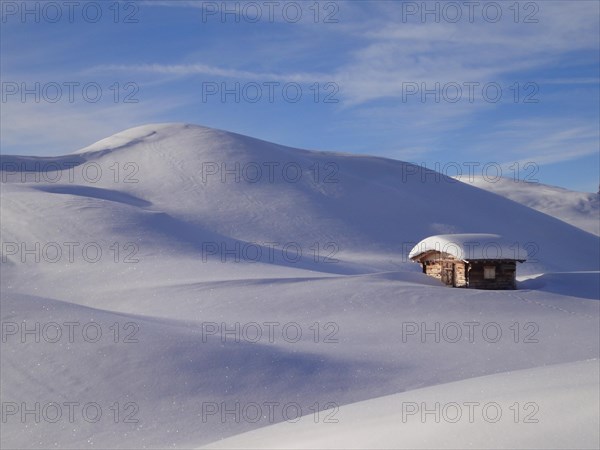 Alpine hut in a winter landscape