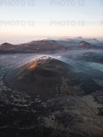 Volcanic crater with clouds