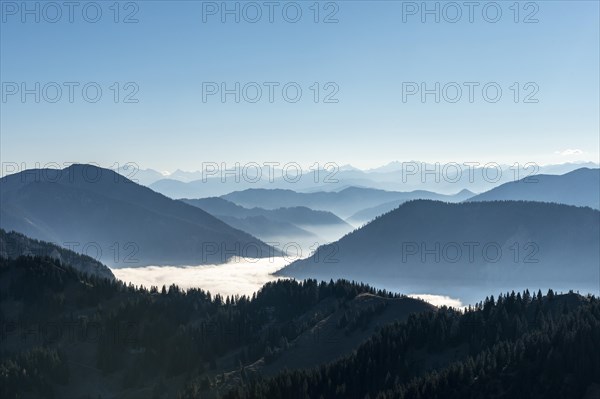 Mountain chains one behind the other in back light