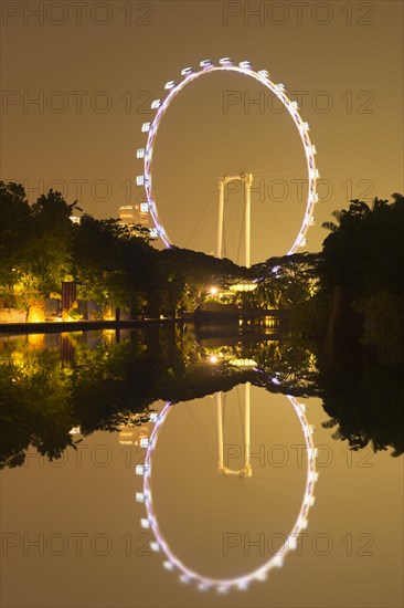 Singapore Flyer reflecting in the water at night