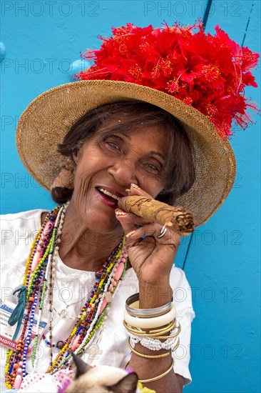 Senior Cuban woman smoking a Cuban cigar