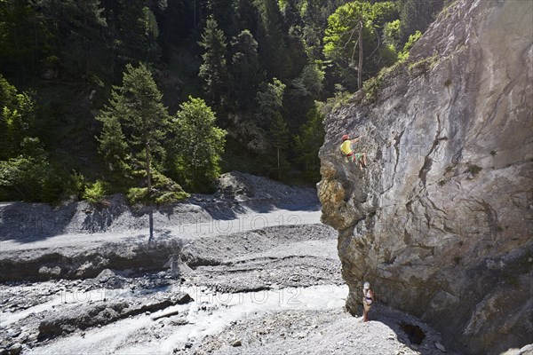 Sport climber climbing a rock face