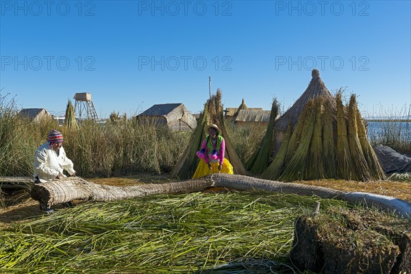 Uros working on the floating islands of the Uros on Lake Titicaca