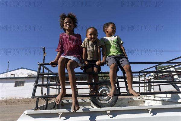 Namibian children on the back of a pick-up