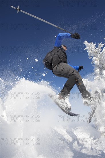 Snowshoe hiker jumping