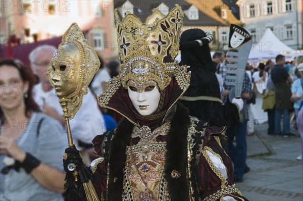 Lavish Baroque costume and a golden and white mask