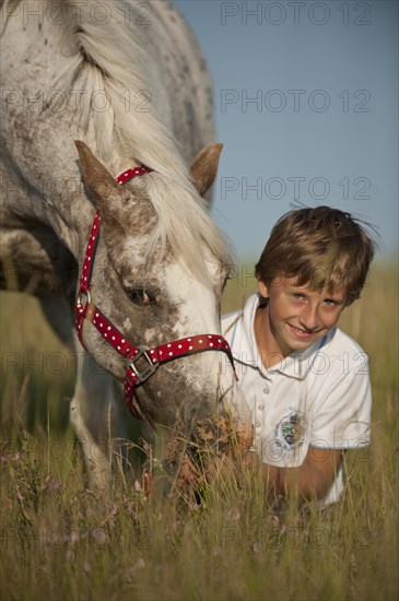 Girl and a pony on a meadow