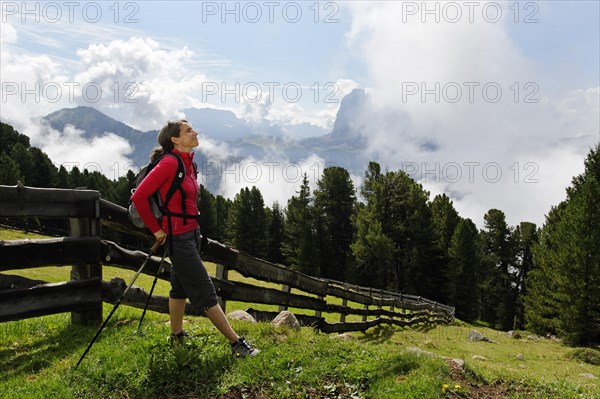 Hiker at the Raschotz or Rasciesa mountain pasture with Mt. Sasso Lungo