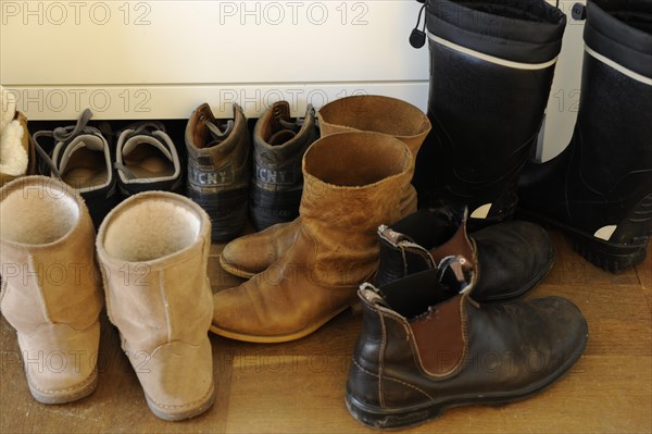 Shoes standing on a wooden floor in a hallway