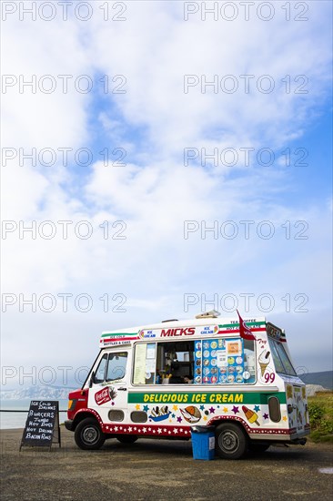 An ice cream van is parked on a coastal car park above Compton Bay on the Isle of Wight