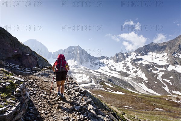 Hiker on the Merano High Mountain Trail ascending to Hohen Wilden Mountain in Pfossental valley