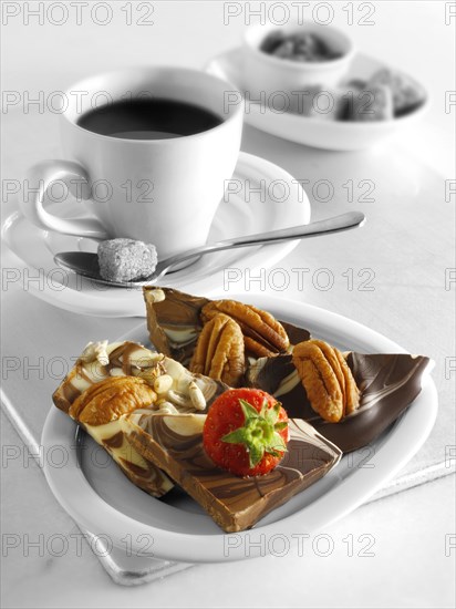 Chocolate swirl biscuits with nuts and fruit and coffee