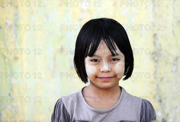 Girl with thanaka paste on her face