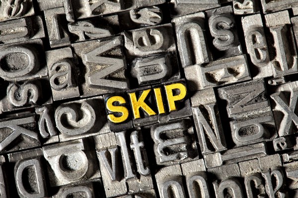 Old lead letters forming the word "SKIP"