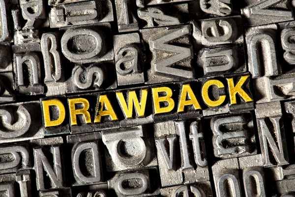 Old lead letters forming the word Drawback