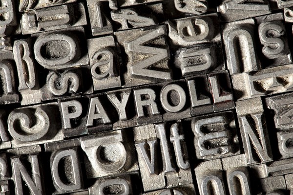 Old lead letters forming the word 'PAYROLL'