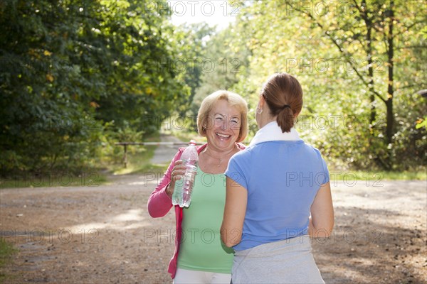 Women taking a break while doing sports outdoors