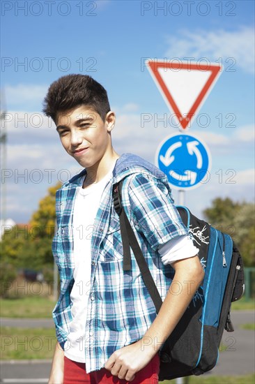 Boy carrying a school bag on the way to school