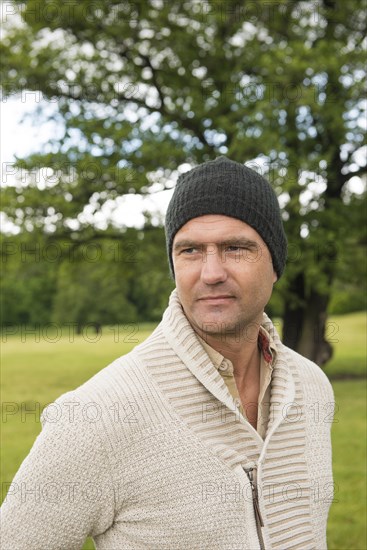 Man wearing a beanie standing in a park