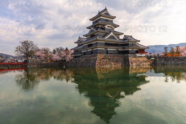 Old Japanese castle reflected in the moat