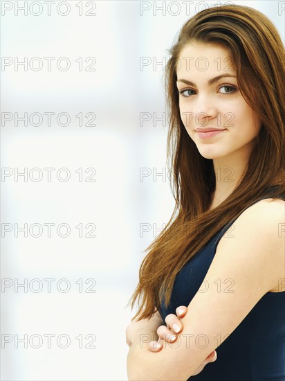 Young woman with her arms crossed