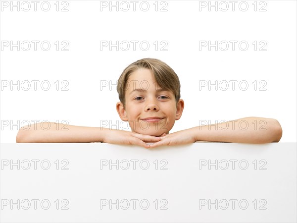 Schoolboy behind a white board