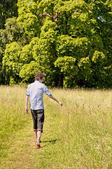 Young man walking in nature - Photo12-imageBROKER-Lars Hallstrom