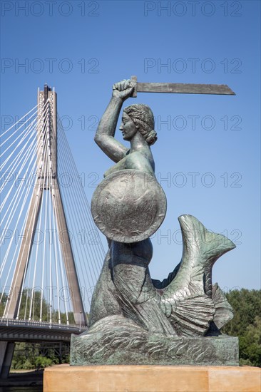 Bronze sculpture of the Warsaw mermaid on the bank of the Vistula River