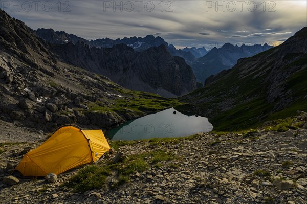 Tent in mountain landscape with Lake Guffelsee and Lechtaler Alps