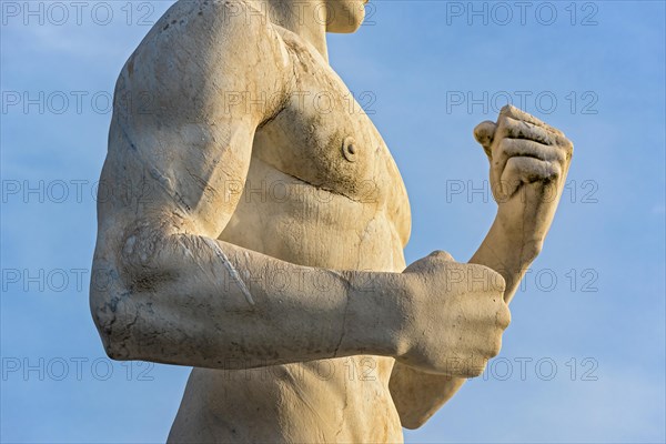 Close-up of fists of fighter statue at Stadio dei Marmi