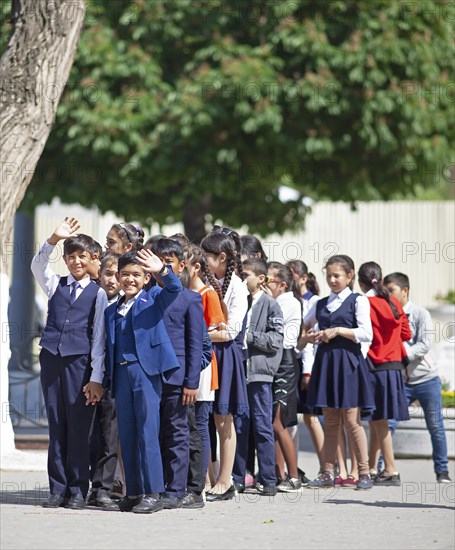 Happy students in evening dress on the university boulevard