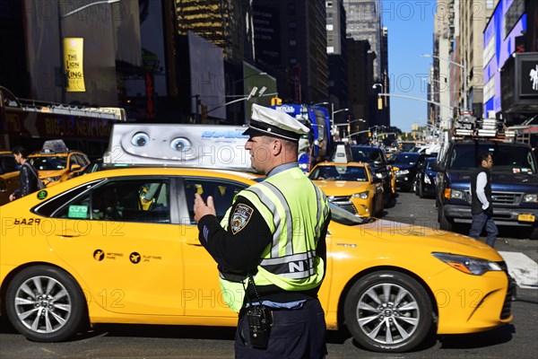 Traffic cop regulates traffic jam at Times Square