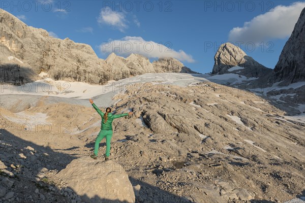 Hiker stretches arms in the air
