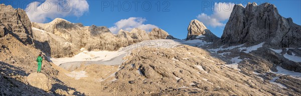 Hiker looks at alpine landscape