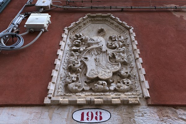 Medieval coat of arms on a house wall
