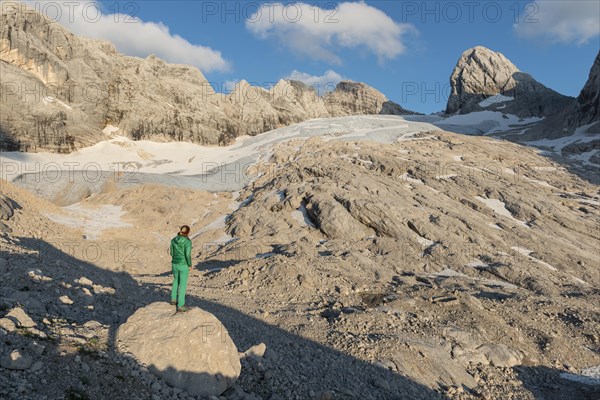 Hiker looks at alpine landscape