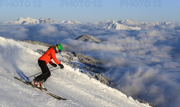 Female skier descending steep slope