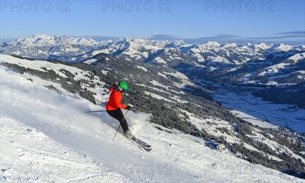 Skier going down steep slope